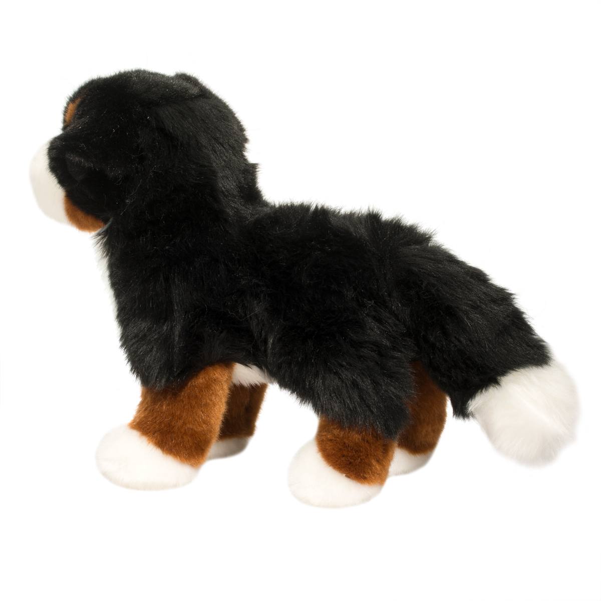 Plush toy dog with black, brown, and white fur on a white background