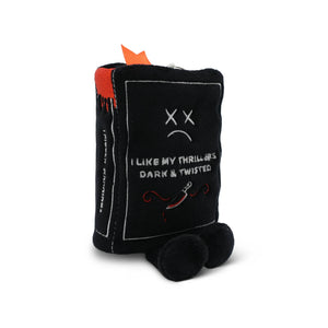 Black plush toy resembling a book with text and a sad face on a white background