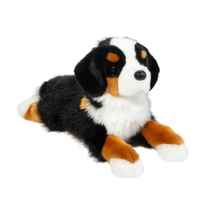 Plush toy of a dog with black, brown, and white fur on a white background