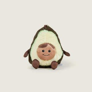A plush avocado toy with a cute cartoon face, sitting upright on a light beige background.