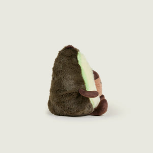 A plush avocado toy shown from the back, featuring dark brown fuzzy outer skin, a cream-colored inner flesh side with a glowing mint green light, and small brown eyes and nose details, set against a solid light gray background.