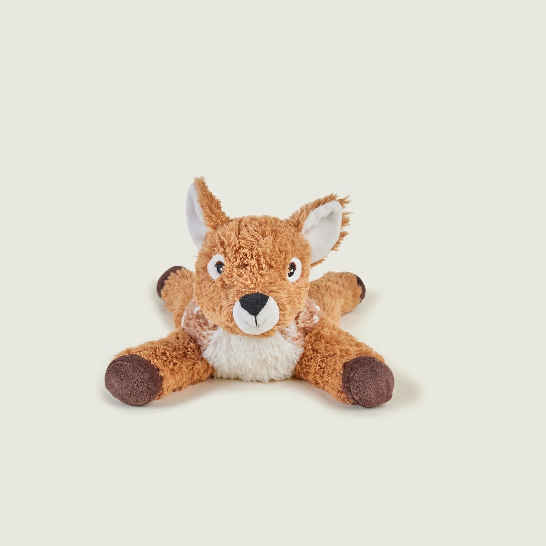 A plush toy deer or dalmatian hybrid stuffed animal with brown fur, a white chest, and dark brown hooves, photographed on a plain light beige background.