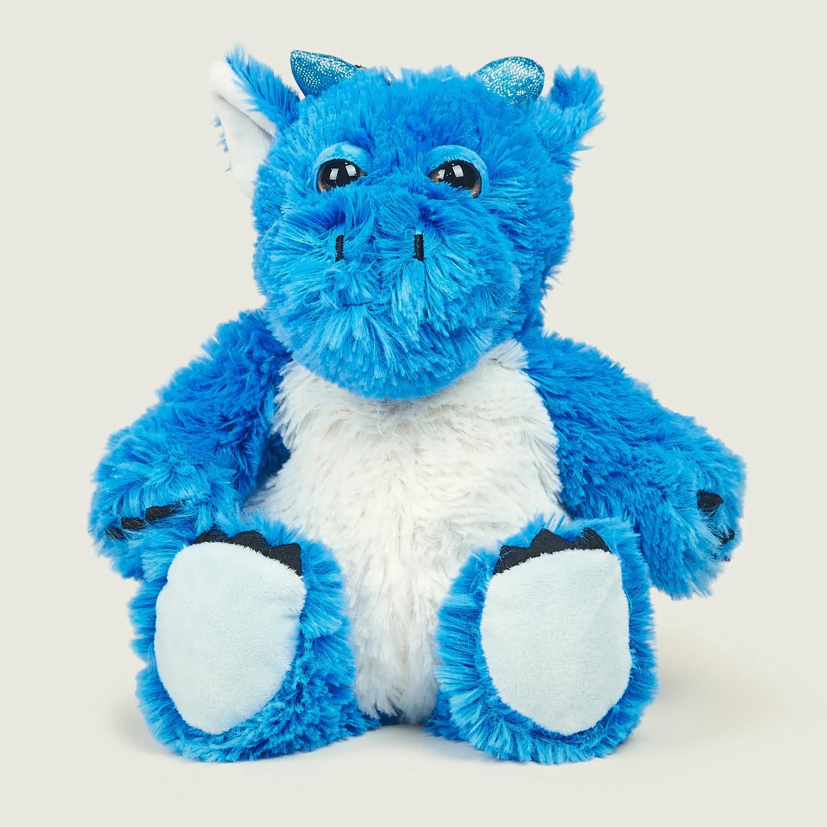 Blue and white plush dragon toy on a light gray background