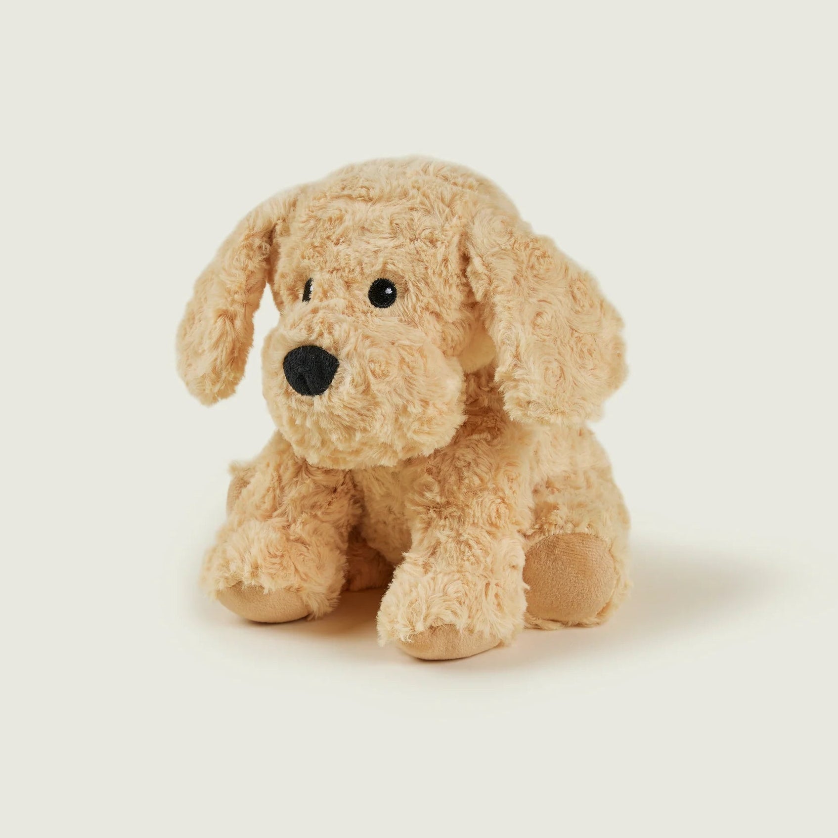 Beige stuffed dog toy on a white background
