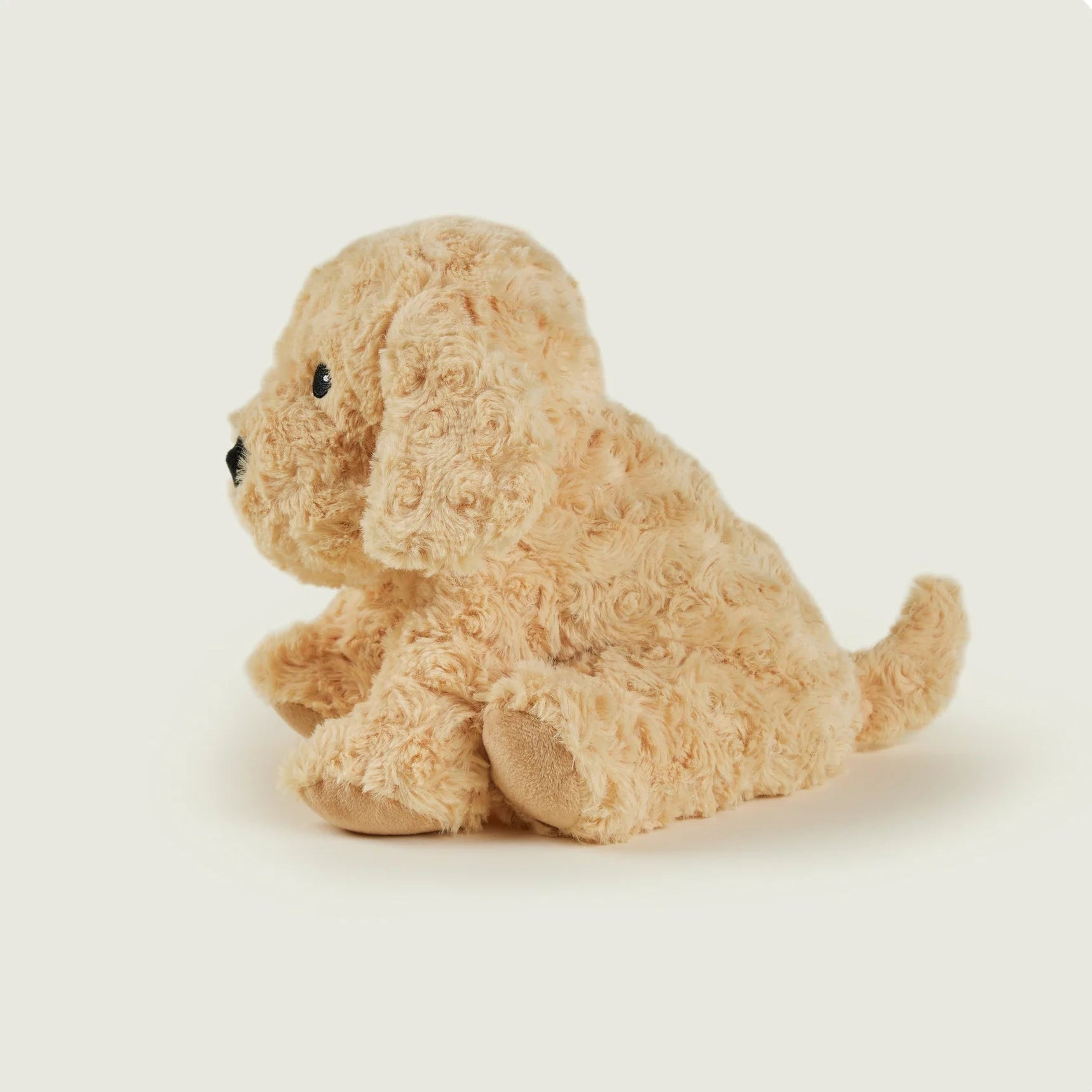 Beige stuffed dog toy on a white background
