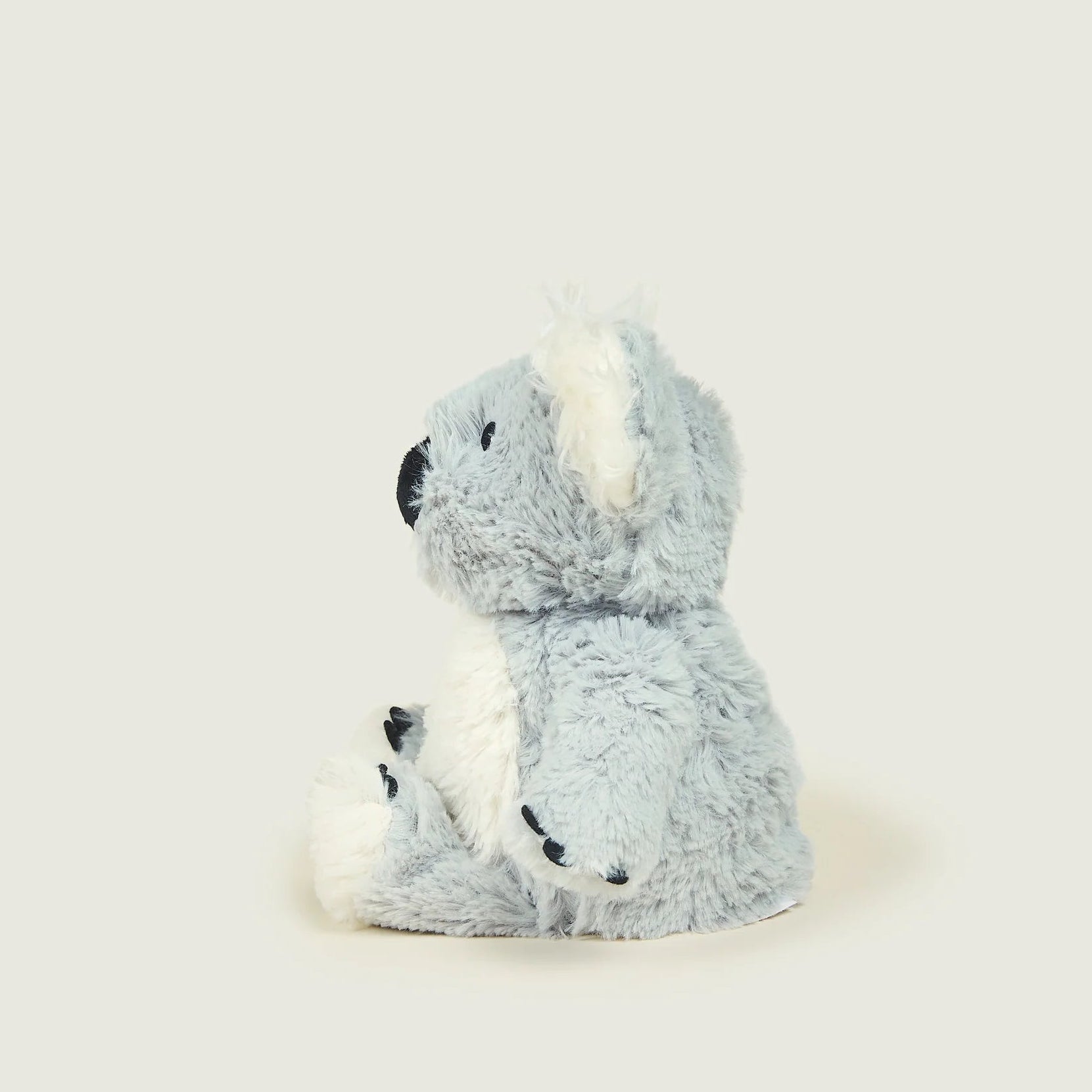 Plush toy sloth on a light gray background