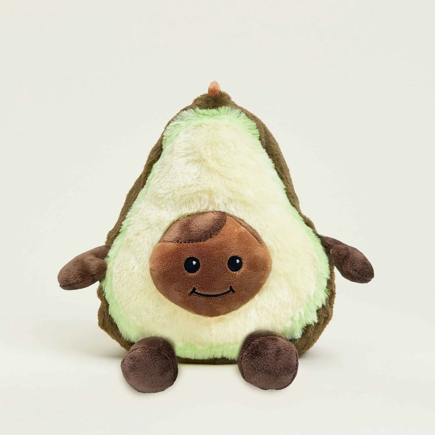 Plush toy avocado with a smiling face on a white background