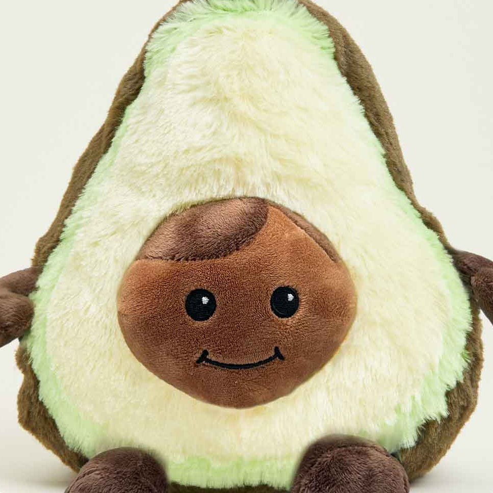 Plush avocado toy with a smiling face on a white background