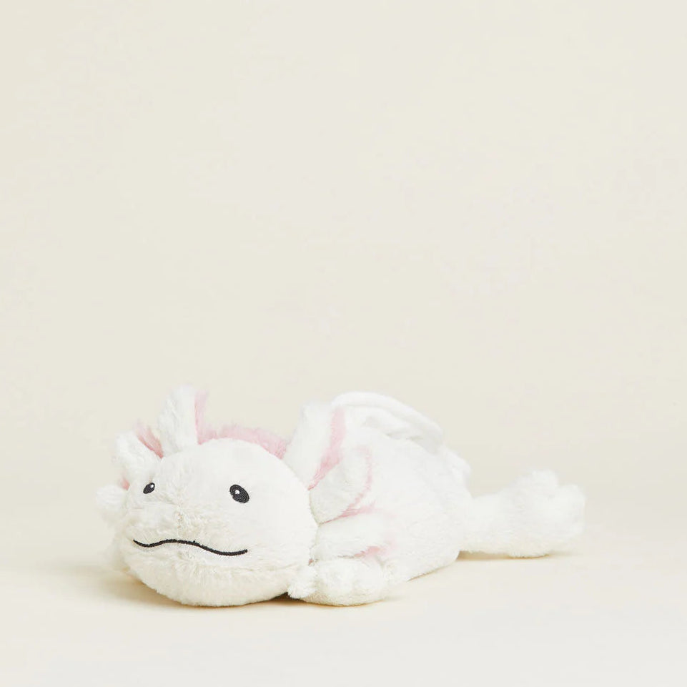 White plush toy with pink accents on a light beige background
