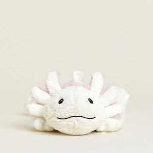 Plush toy with a sad expression on a beige background