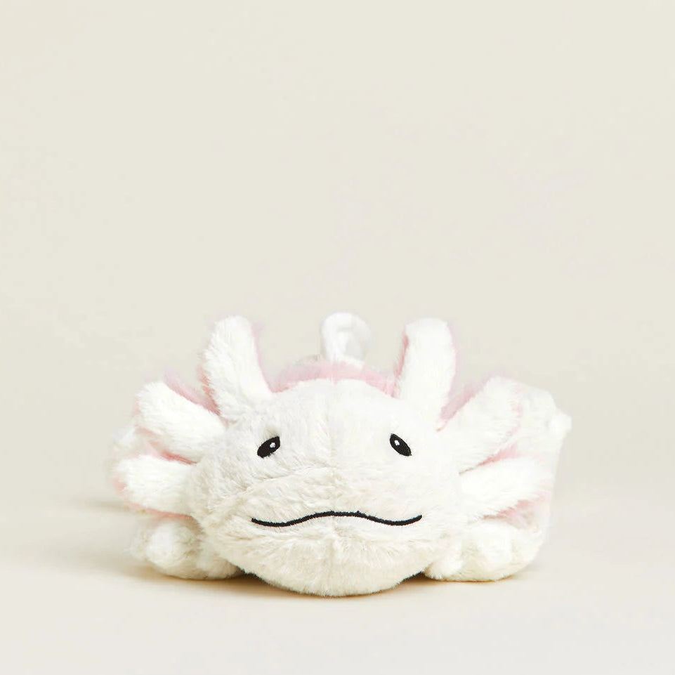 Plush toy with a sad expression on a beige background