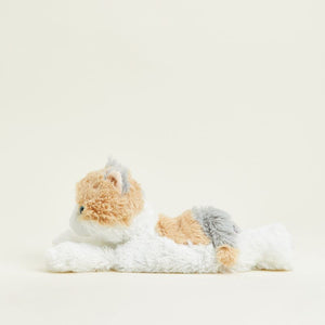 A plush cat toy lying down, featuring fluffy white fur, peach-brown patches, and gray ears and tail, photographed on a clean off-white background.