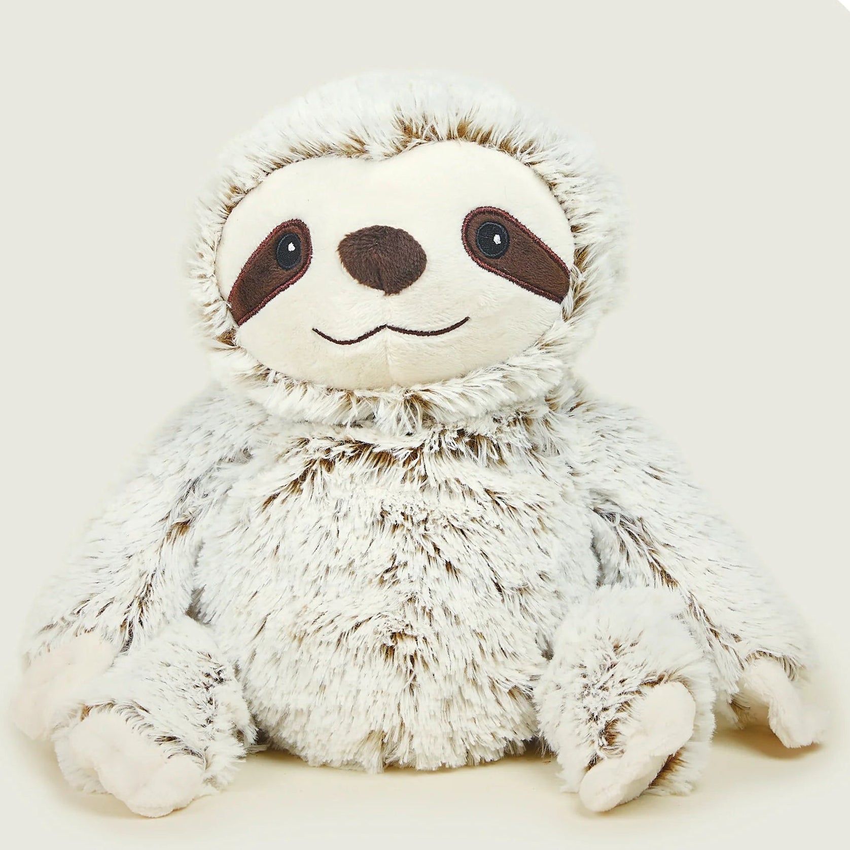 Plush toy sloth on a light beige background