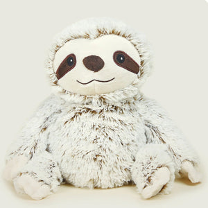 Plush toy sloth on a light beige background