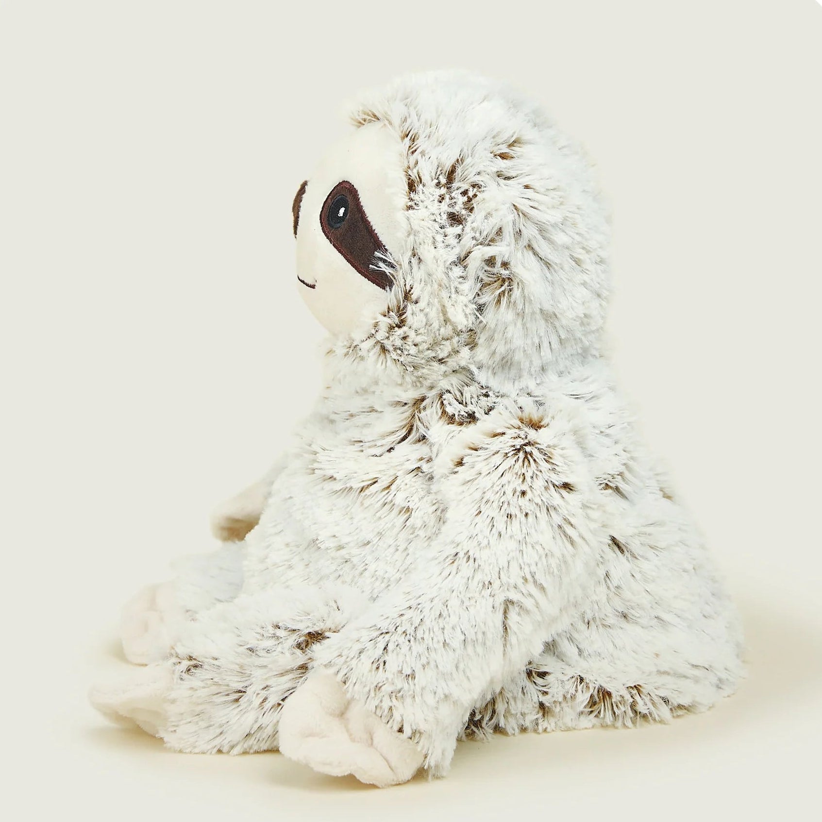 Plush toy sloth on a light gray background