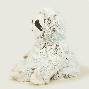 Plush toy sloth on a light gray background