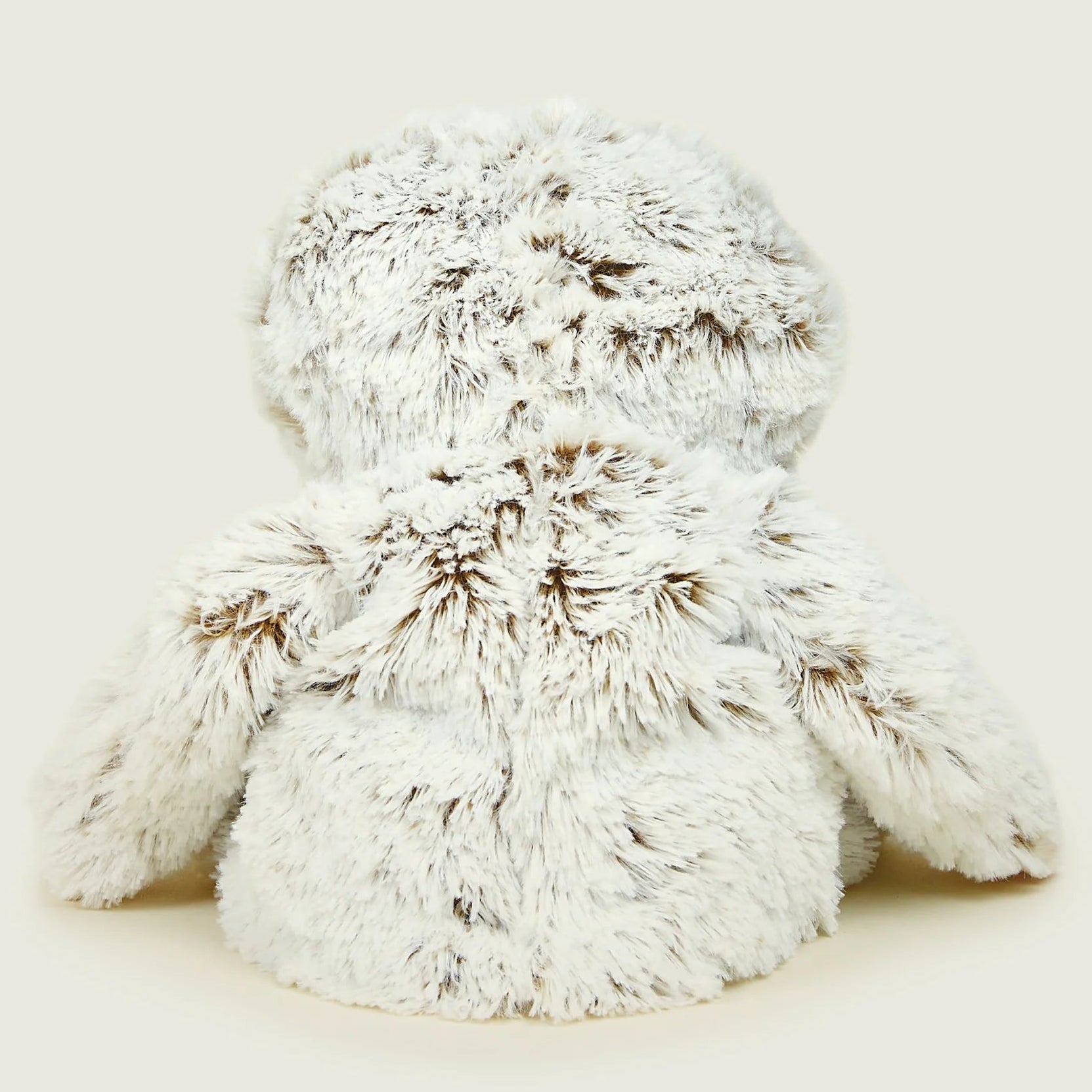 White fluffy bunny toy on a light beige background