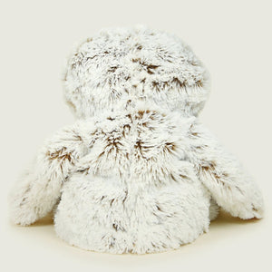 White fluffy bunny toy on a light beige background