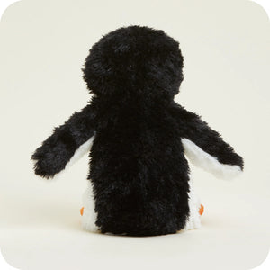 A plush penguin toy shown from the back, featuring black shaggy fur, white wings and feet, and small orange beaks, set against a plain off-white background.