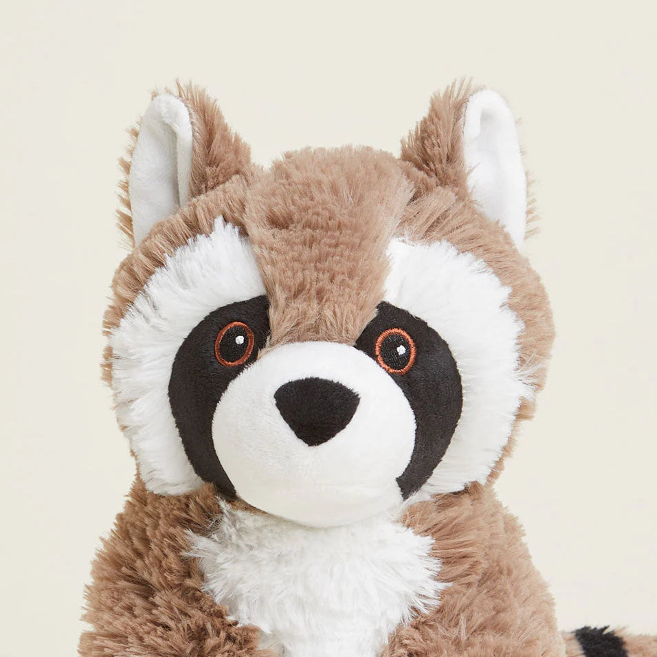 Plush raccoon toy on a beige background