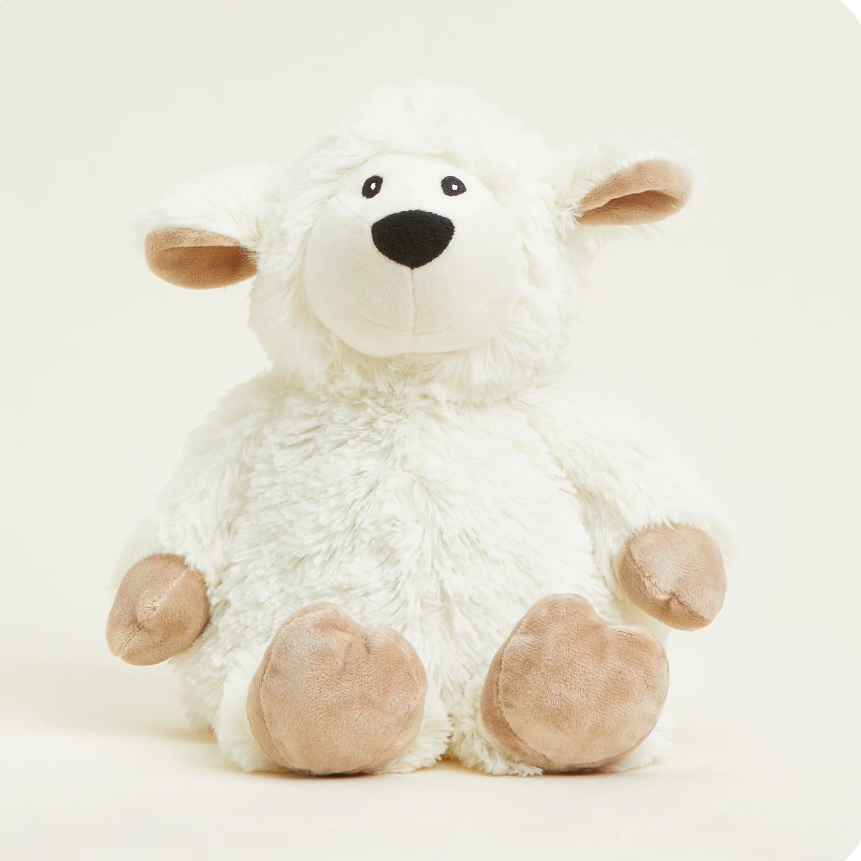 White plush lamb toy with brown feet on a white background