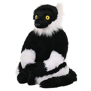 A black and white striped lemur plush toy with bright yellow eyes, sitting upright against a solid white background.
