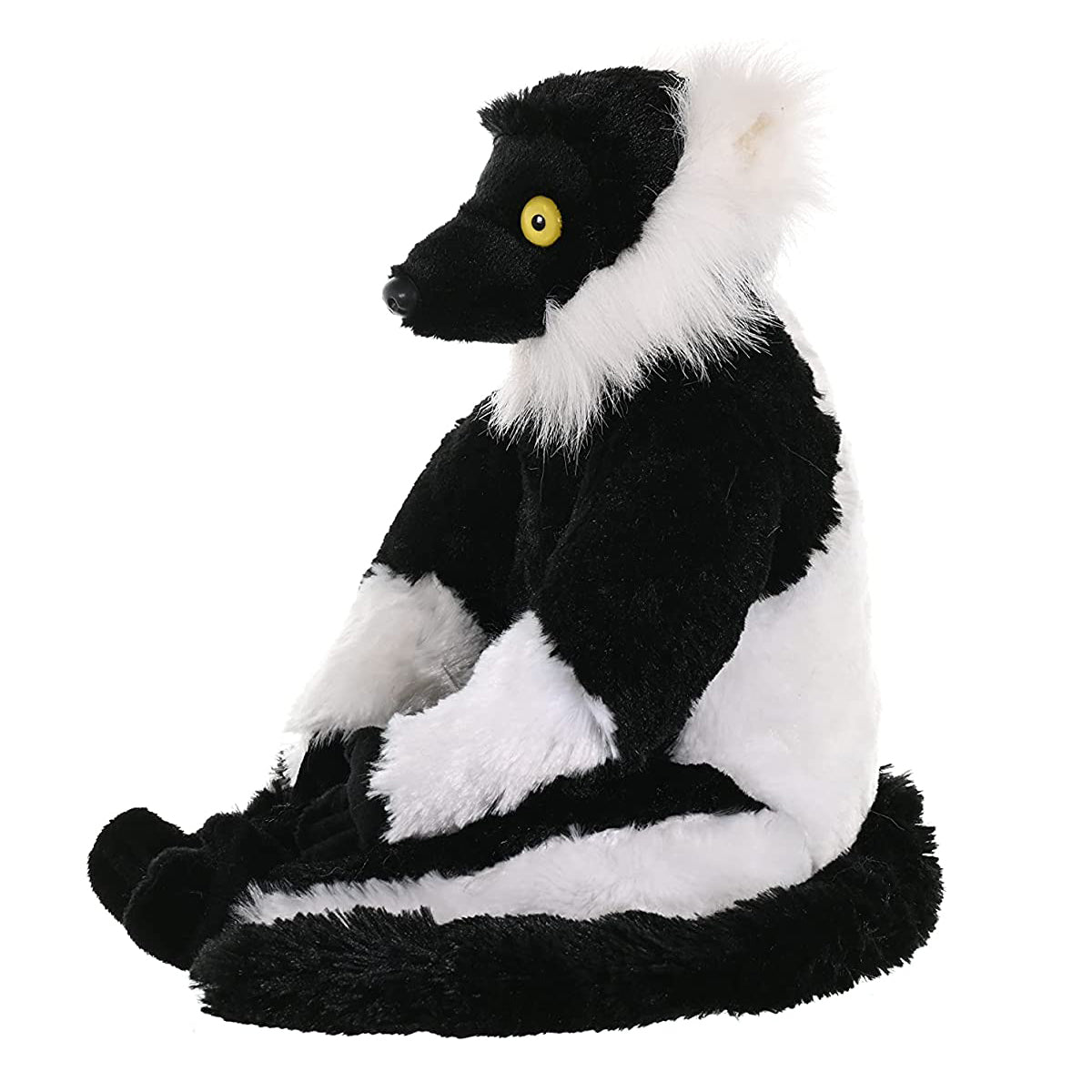 A plush toy lemur sitting upright, featuring black and white fur with a yellow eye, isolated on a white background.