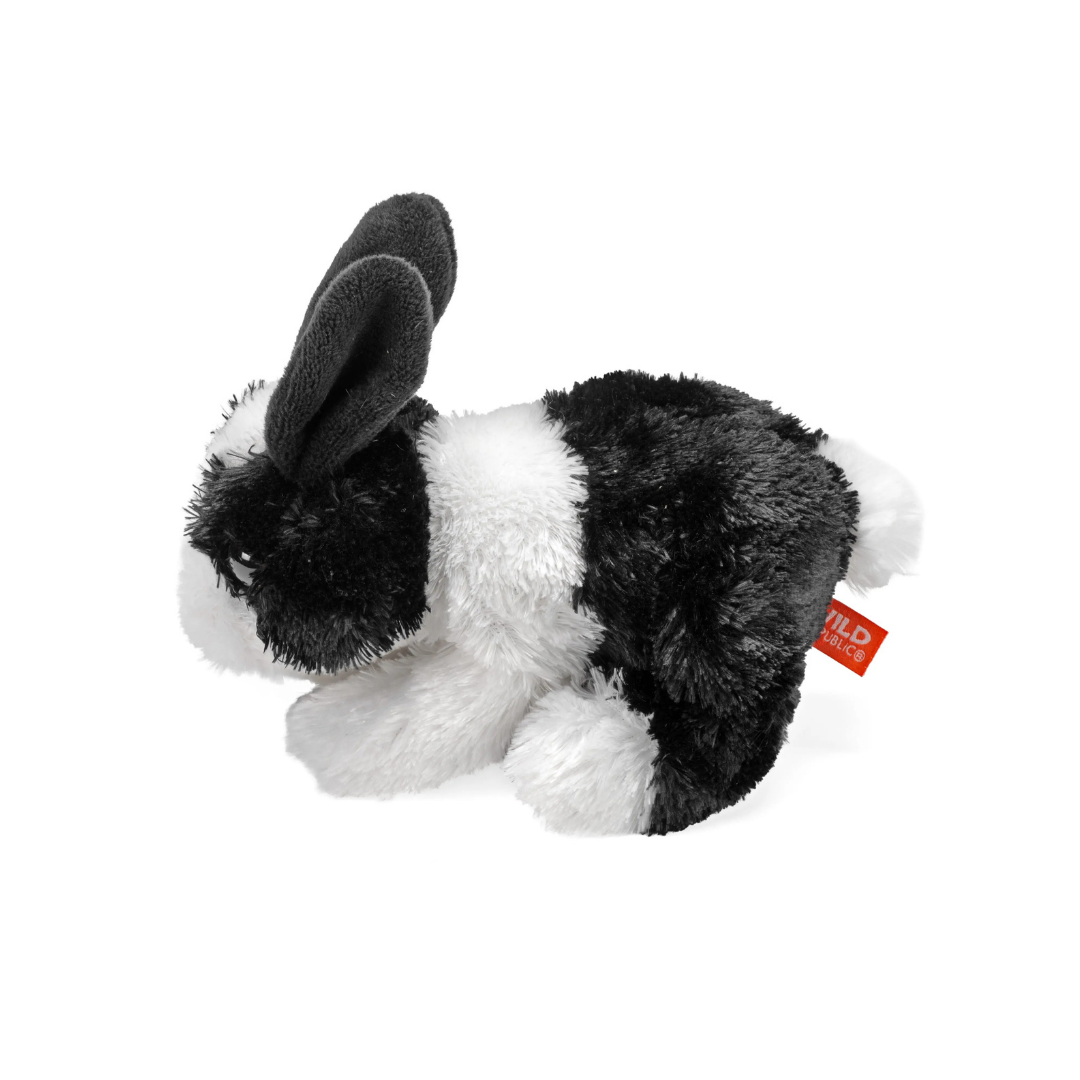 Plush toy rabbit with black and white fur on a white background