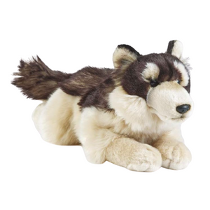 Plush toy husky lying down on a white background