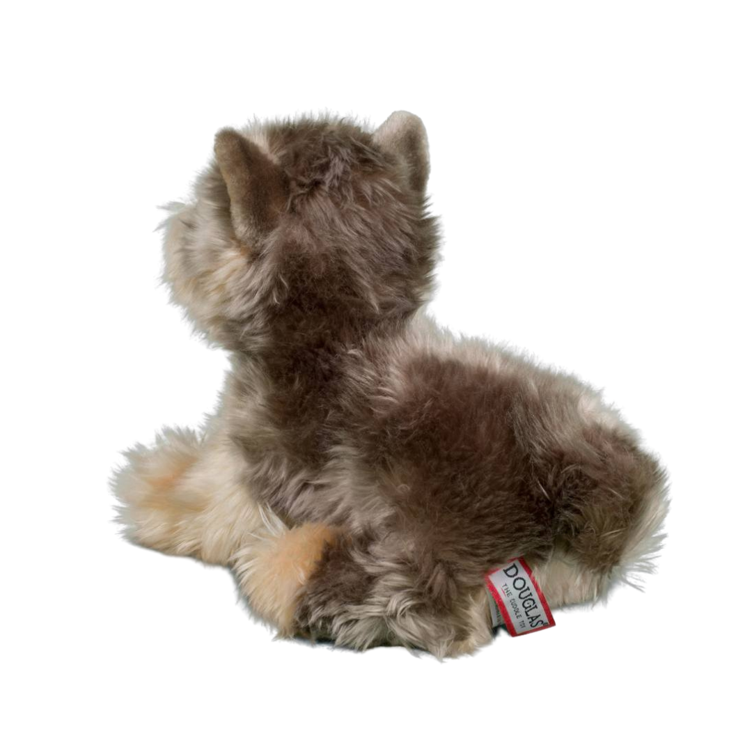 Plush toy resembling a small dog with a visible brand tag on a white background