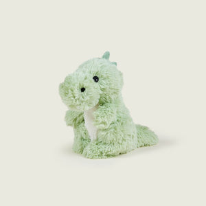 A light green plush dinosaur toy with a white belly, black bead eyes, and small horns on its head, sitting against a solid off-white background.
