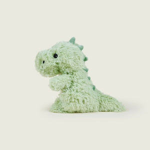 A light green plush dinosaur toy with small dark eyes and a textured, fuzzy body, shown against a plain light beige background.