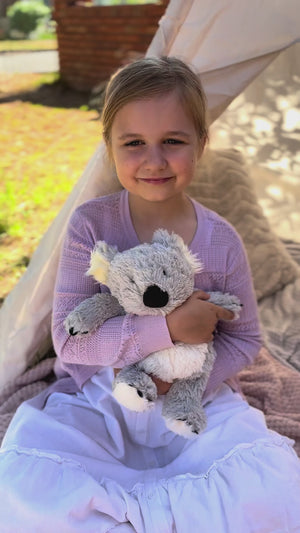 Girl holding Koala plushie - Warmies brand - weighted, lavender scented heat bag video