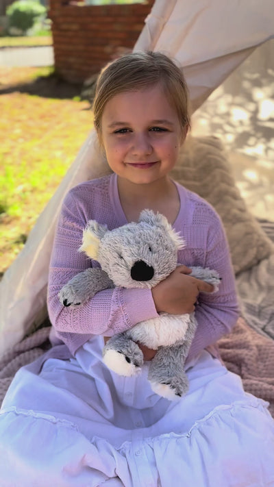 Girl holding Koala plushie - Warmies brand - weighted, lavender scented heat bag video