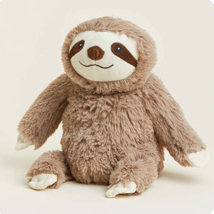 Plush toy sloth on a light beige background