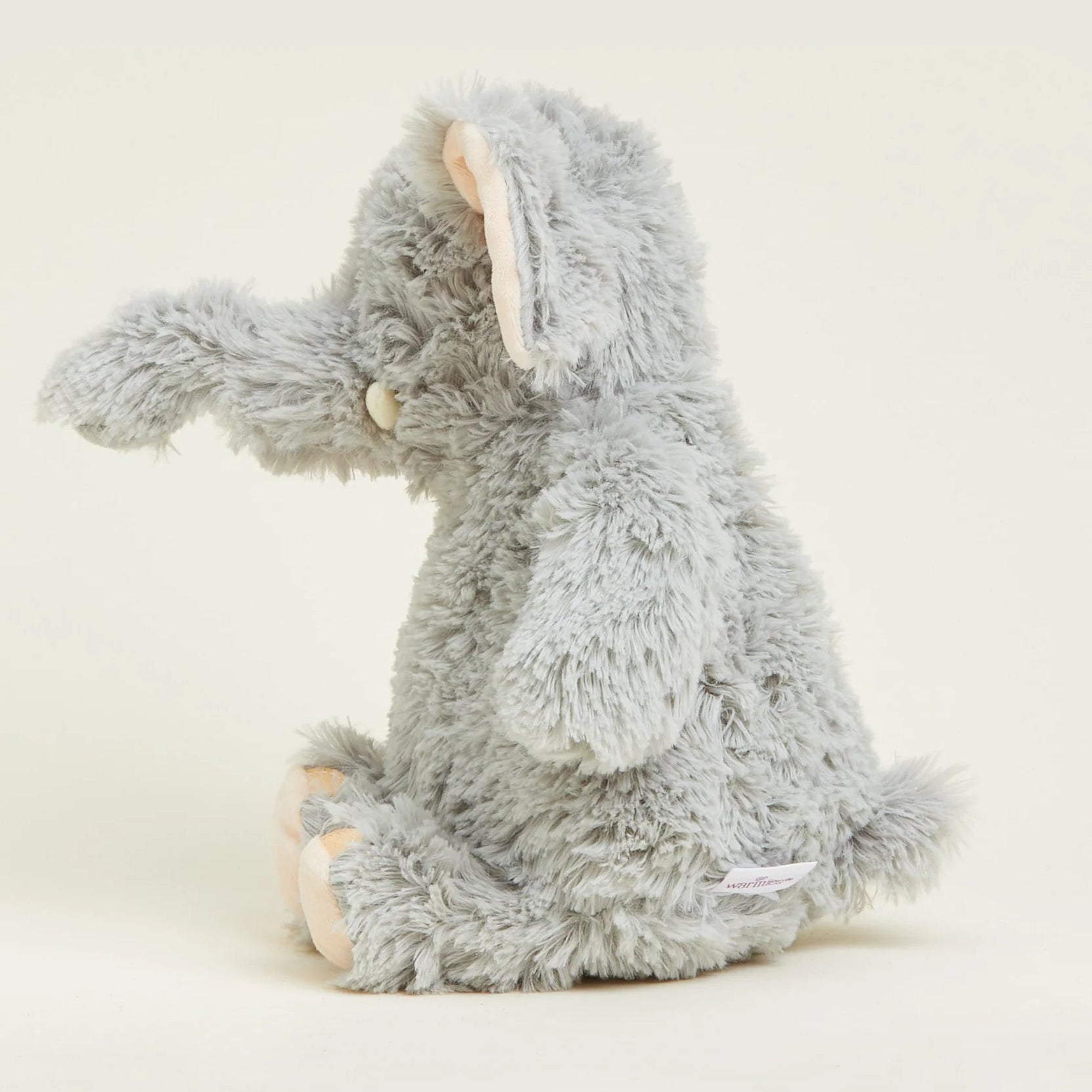 Gray plush elephant toy on a white background