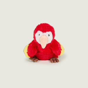 A plush toy parrot with bright red feathers, yellow wings, a white face, and a peach-colored beak, sitting against a solid light gray background.